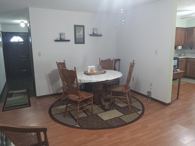 6978 Cook-Jones Rd, Waynesville, OH 45068 - dining room with light wood-type flooring and baseboards