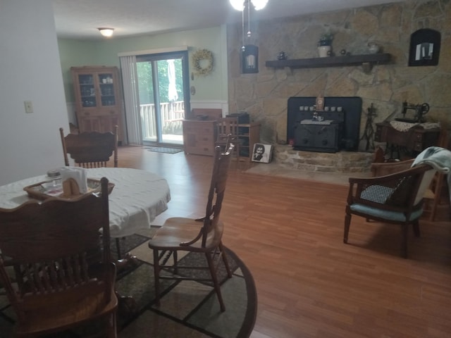 6978 Cook-Jones Rd, Waynesville, OH 45068 - dining area featuring a wood stove and wood finished floors