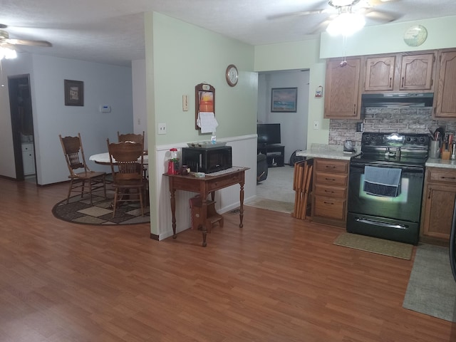 6978 Cook-Jones Rd, Waynesville, OH 45068 - kitchen featuring black appliances, a ceiling fan, under cabinet range hood, and light wood finished floors