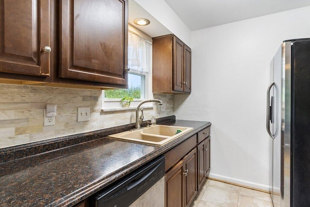 3748 Wagner Ct, Grove City, OH 43123 - kitchen featuring freestanding refrigerator, dishwashing machine, dark countertops, and backsplash
