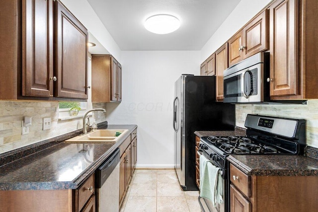 3748 Wagner Ct, Grove City, OH 43123 - kitchen featuring stainless steel appliances, dark countertops, decorative backsplash, and light tile patterned flooring