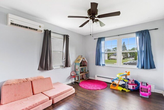 3748 Wagner Ct, Grove City, OH 43123 - playroom with an AC wall unit, wood finished floors, and ceiling fan
