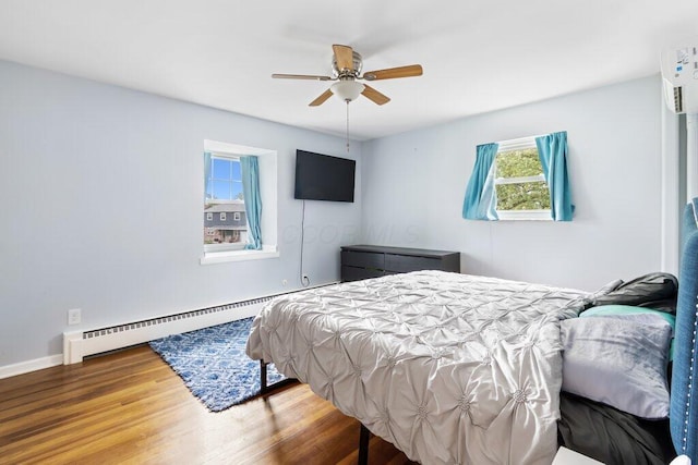 3748 Wagner Ct, Grove City, OH 43123 - bedroom featuring a baseboard heating unit, wood finished floors, and ceiling fan