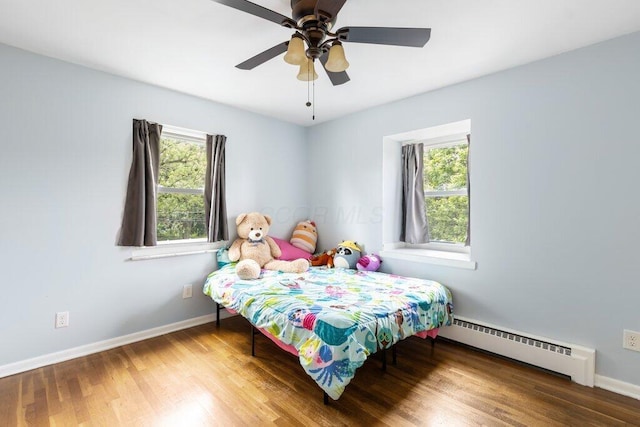 3748 Wagner Ct, Grove City, OH 43123 - bedroom featuring a baseboard radiator, wood finished floors, and ceiling fan