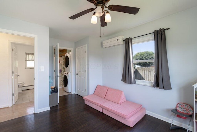 3748 Wagner Ct, Grove City, OH 43123 - sitting room featuring stacked washer and clothes dryer, a baseboard radiator, an AC wall unit, wood finished floors, and ceiling fan