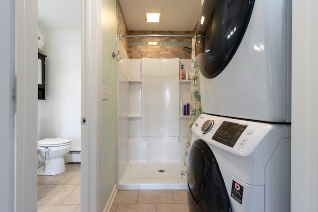 3748 Wagner Ct, Grove City, OH 43123 - washroom with stacked washer / drying machine, light tile patterned floors, and a baseboard heating unit
