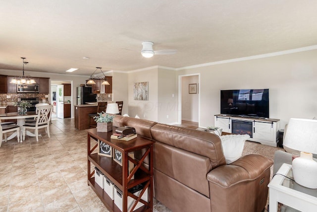 2591 Apple Valley Dr, Howard, OH 43028 - living room with ornamental molding, a ceiling fan, and a chandelier