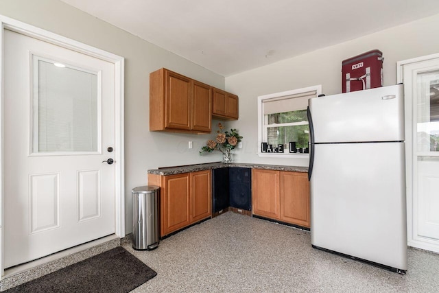 2591 Apple Valley Dr, Howard, OH 43028 - kitchen with freestanding refrigerator, brown cabinets, and dark countertops