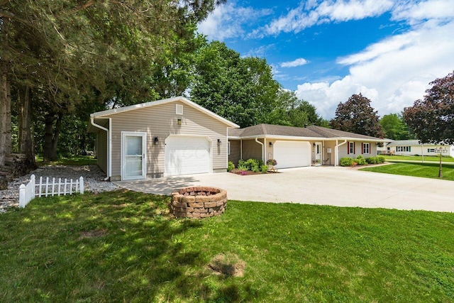 2591 Apple Valley Dr, Howard, OH 43028 - ranch-style house with an attached garage, an outdoor fire pit, and driveway