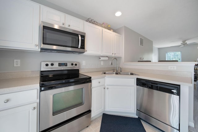 6295 Royal Tern Xing, Columbus, OH 43230 - kitchen with appliances with stainless steel finishes, a peninsula, a ceiling fan, white cabinets, and light countertops