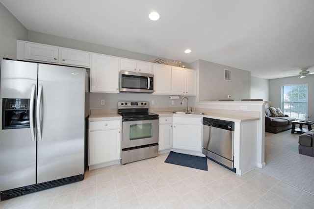 6295 Royal Tern Xing, Columbus, OH 43230 - kitchen with appliances with stainless steel finishes, open floor plan, a peninsula, light countertops, and recessed lighting