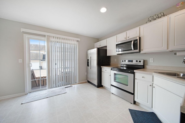 6295 Royal Tern Xing, Columbus, OH 43230 - kitchen with appliances with stainless steel finishes, white cabinetry, light countertops, and recessed lighting