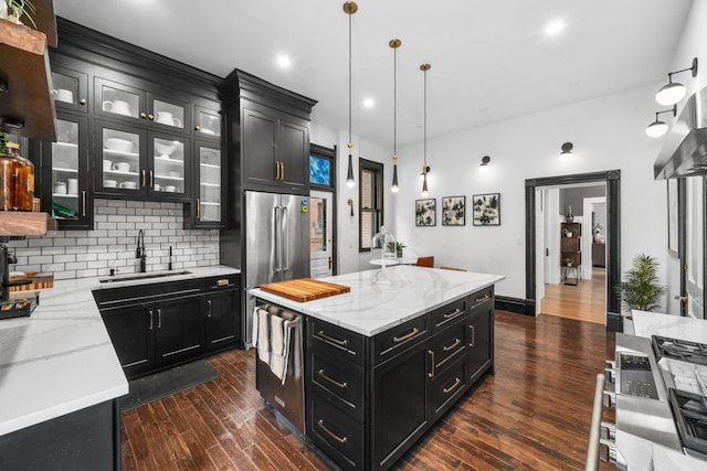 810 Franklin Ave, Columbus, OH 43205 - kitchen with dark cabinets, a center island, tasteful backsplash, dark wood-style flooring, and glass insert cabinets