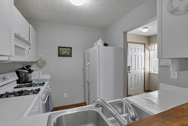 224 Macandrews Way Unit 60A, Blacklick, OH 43004 - kitchen featuring white appliances, white cabinets, a textured ceiling, and light countertops