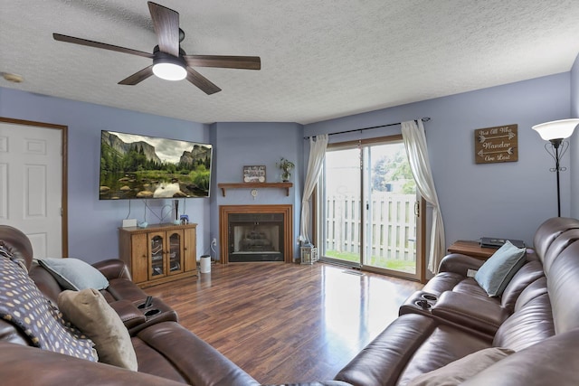 224 Macandrews Way Unit 60A, Blacklick, OH 43004 - living room featuring a textured ceiling, wood finished floors, a fireplace, and a ceiling fan