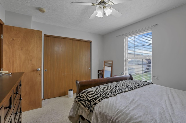 224 Macandrews Way Unit 60A, Blacklick, OH 43004 - carpeted bedroom featuring a closet, a textured ceiling, and a ceiling fan
