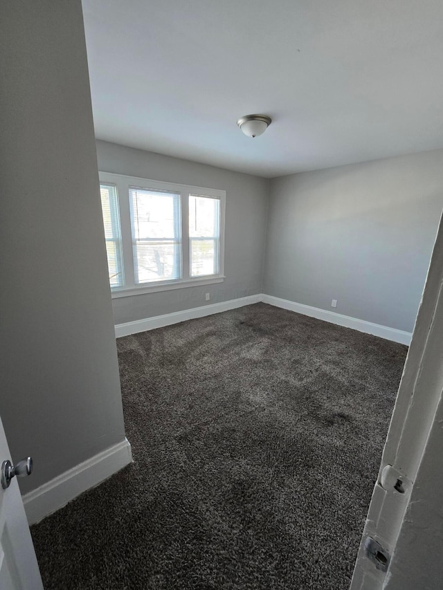 2205-2207 Sullivant Ave, Columbus, OH 43223 - empty room featuring baseboards and dark carpet