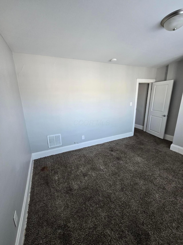 2205-2207 Sullivant Ave, Columbus, OH 43223 - spare room featuring baseboards and dark carpet