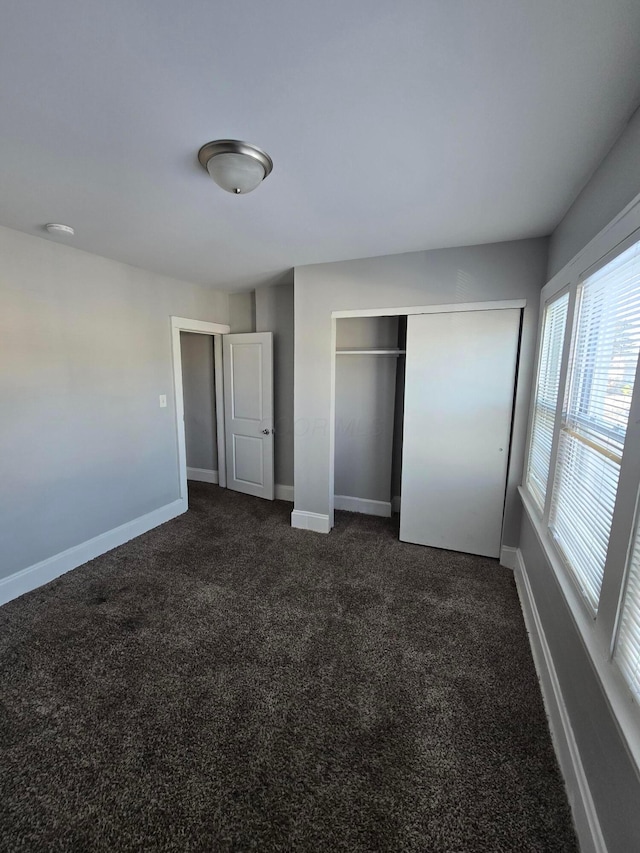 2205-2207 Sullivant Ave, Columbus, OH 43223 - unfurnished bedroom featuring dark colored carpet and a closet