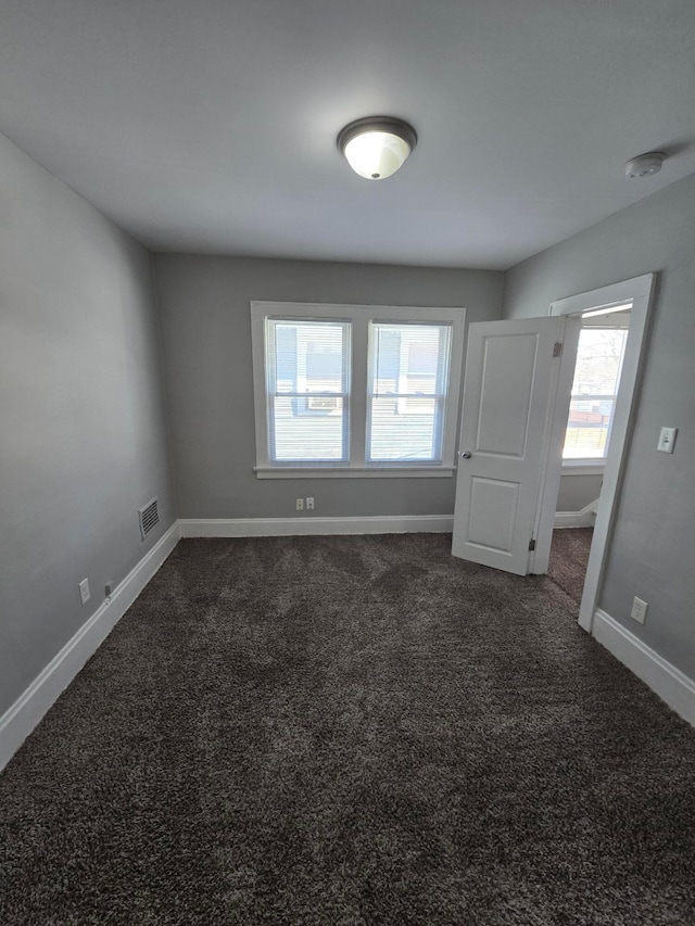2205-2207 Sullivant Ave, Columbus, OH 43223 - empty room featuring dark colored carpet and a smoke detector