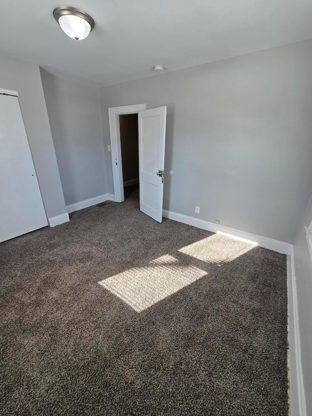 2205-2207 Sullivant Ave, Columbus, OH 43223 - unfurnished bedroom with dark carpet and baseboards