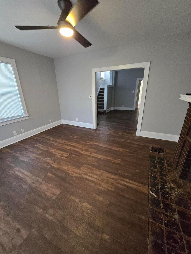 2205-2207 Sullivant Ave, Columbus, OH 43223 - unfurnished room featuring a ceiling fan, stairs, wood finished floors, and a fireplace
