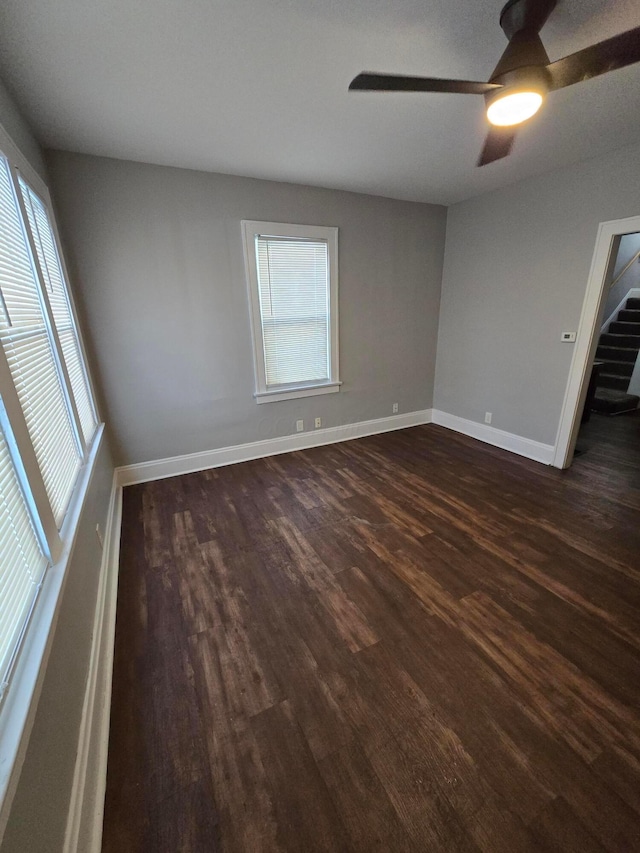 2205-2207 Sullivant Ave, Columbus, OH 43223 - unfurnished room with dark wood-type flooring, ceiling fan, and stairs