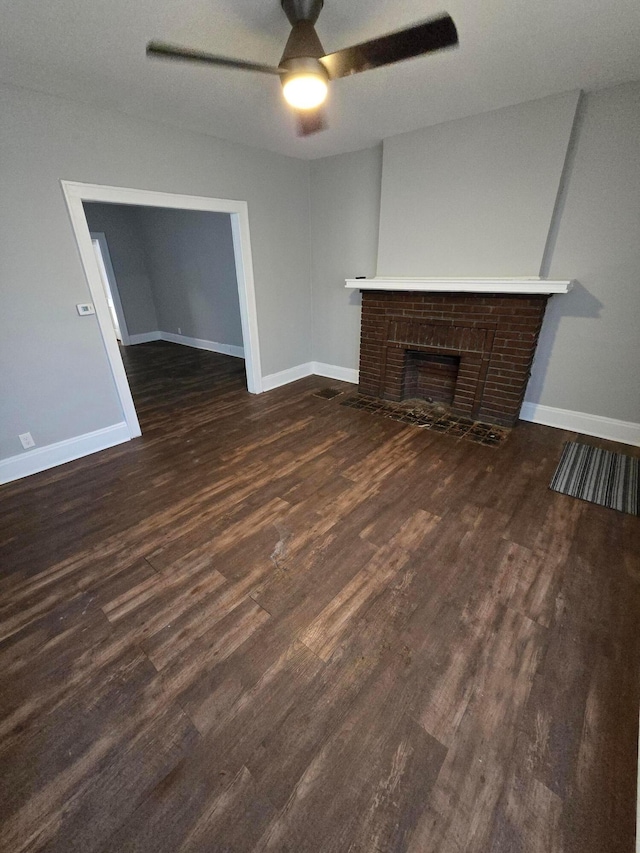 2205-2207 Sullivant Ave, Columbus, OH 43223 - unfurnished living room featuring a ceiling fan, dark wood finished floors, and a fireplace