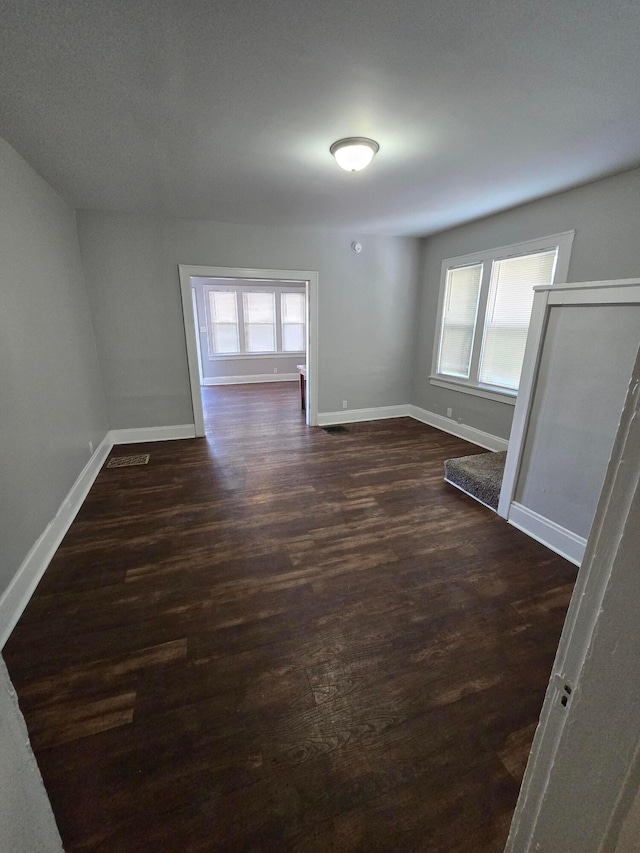 2205-2207 Sullivant Ave, Columbus, OH 43223 - empty room featuring baseboards and dark wood finished floors