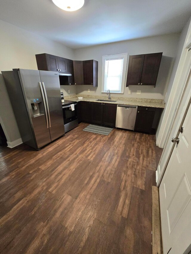 2205-2207 Sullivant Ave, Columbus, OH 43223 - kitchen featuring appliances with stainless steel finishes, dark wood-type flooring, dark brown cabinets, and light stone countertops