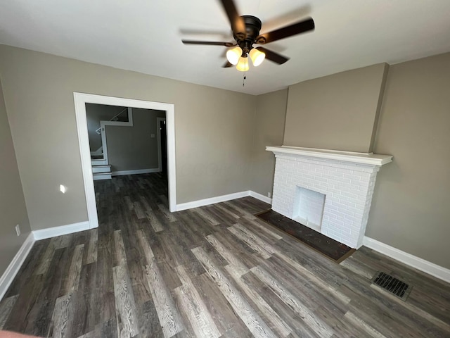1514-1516 E 26th Ave, Columbus, OH 43211 - unfurnished living room with a ceiling fan, wood finished floors, and a brick fireplace