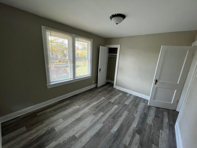 1514-1516 E 26th Ave, Columbus, OH 43211 - unfurnished bedroom with dark wood-type flooring and a closet
