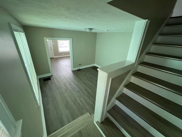 1514-1516 E 26th Ave, Columbus, OH 43211 - staircase featuring wood finished floors and a textured ceiling