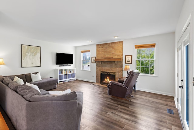 271 Crawford Ct, Westerville, OH 43082 - living area featuring plenty of natural light, a brick fireplace, and dark wood-style flooring