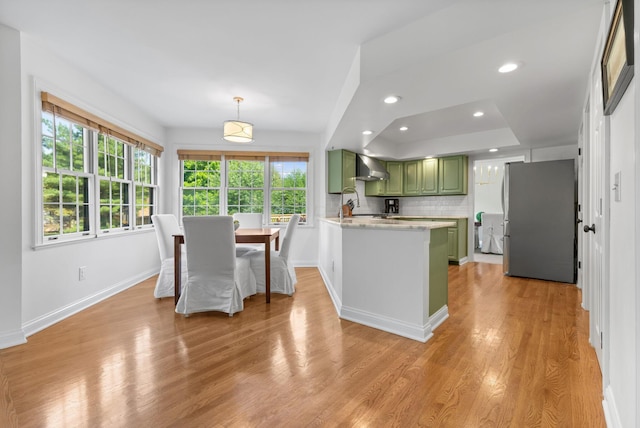 271 Crawford Ct, Westerville, OH 43082 - kitchen with green cabinets, freestanding refrigerator, light wood-type flooring, light countertops, and a peninsula