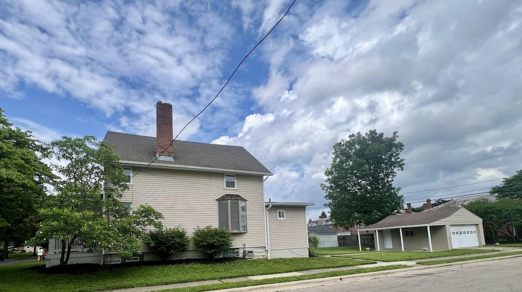 874 Chelsea Ave, Bexley, OH 43209 - view of property exterior featuring a chimney, an outbuilding, and driveway