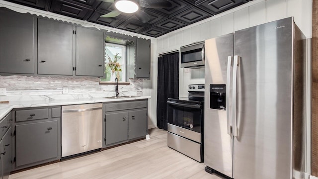 215 S Market St, Somerset, OH 43783 - kitchen featuring appliances with stainless steel finishes, gray cabinets, an ornate ceiling, light countertops, and light wood-style flooring