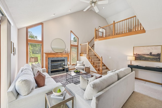 1318 Retreat Ln, New Albany, OH 43054 - living room with high vaulted ceiling, stairway, a ceiling fan, carpet, and a premium fireplace