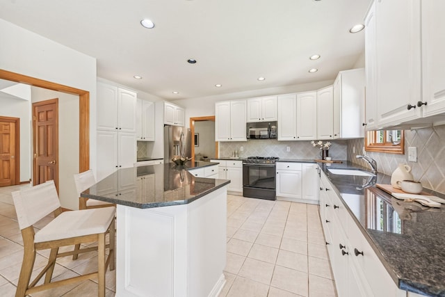 1318 Retreat Ln, New Albany, OH 43054 - kitchen featuring gas range, black microwave, stainless steel fridge, light tile patterned flooring, and tasteful backsplash