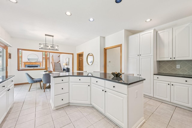 1318 Retreat Ln, New Albany, OH 43054 - kitchen with dark countertops, light tile patterned floors, recessed lighting, tasteful backsplash, and white cabinetry