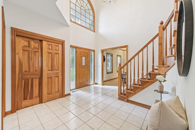 1318 Retreat Ln, New Albany, OH 43054 - entryway featuring stairs, light tile patterned flooring, and a towering ceiling