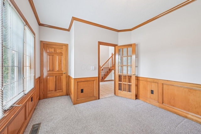 1318 Retreat Ln, New Albany, OH 43054 - empty room featuring wainscoting, ornamental molding, light colored carpet, and french doors
