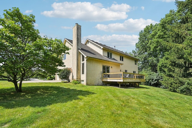 1318 Retreat Ln, New Albany, OH 43054 - back of house featuring a chimney, a wooden deck, a yard, and stucco siding