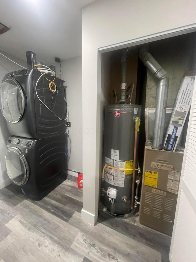 3107 Huntington Dr, Columbus, OH 43207 - utility room with water heater, stacked washer / dryer, and heating unit