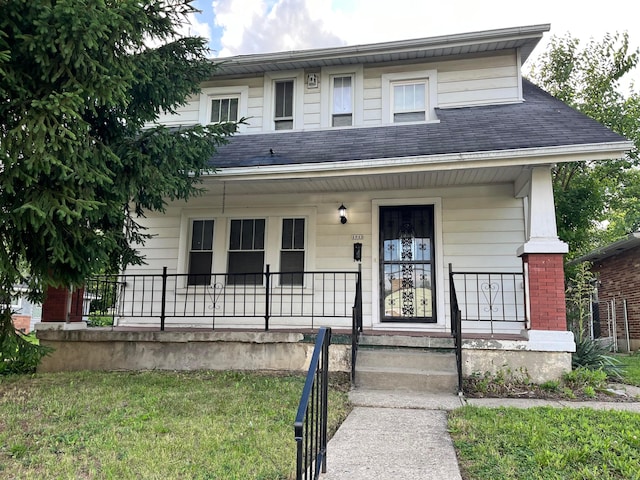 1015 Fairwood Ave, Columbus, OH 43206 - view of front of home with covered porch, roof with shingles, and a front yard