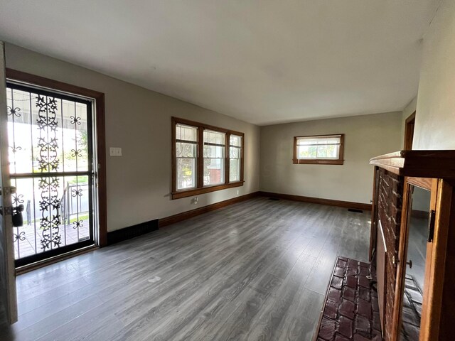 1015 Fairwood Ave, Columbus, OH 43206 - unfurnished living room with dark wood-style flooring and baseboards