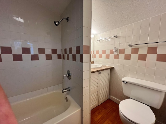 1015 Fairwood Ave, Columbus, OH 43206 - full bath with wood finished floors, vanity, bathing tub / shower combination, and tile walls