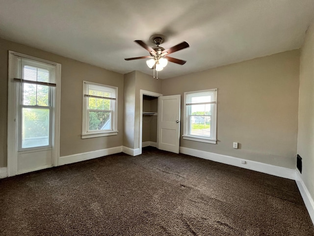 1015 Fairwood Ave, Columbus, OH 43206 - unfurnished bedroom featuring dark carpet, a closet, and a ceiling fan
