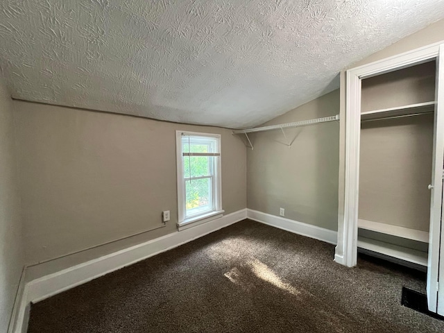 1015 Fairwood Ave, Columbus, OH 43206 - unfurnished bedroom with a textured ceiling, lofted ceiling, and dark colored carpet