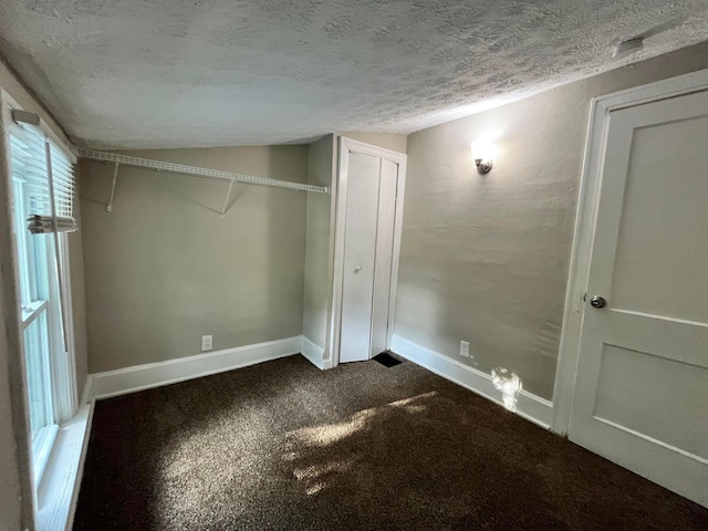 1015 Fairwood Ave, Columbus, OH 43206 - unfurnished bedroom with a textured ceiling, dark colored carpet, lofted ceiling, and a closet